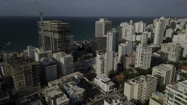 Drone flies forward as it lowers over Condado neighborhood in the late afternoon in San Juan, Puerto Rico