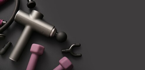 Percussive massager, nozzles and sports equipment on dark background with space for text