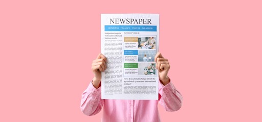 Woman holding newspapers on pink background