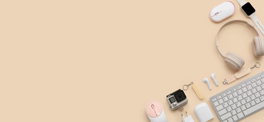 Set of modern devices and gadgets on beige background with space for text