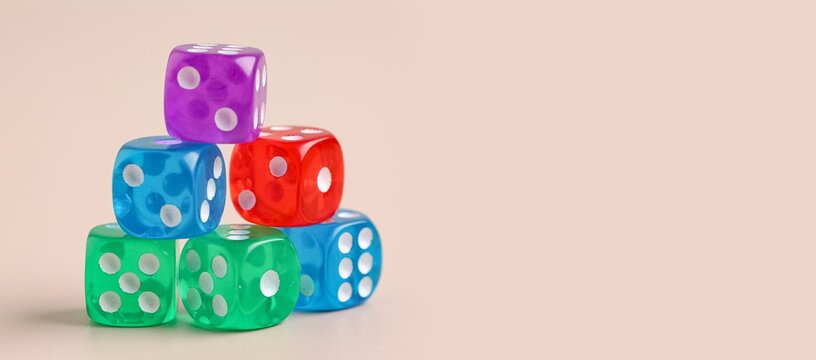 Many dices on beige background with space for text