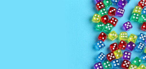 Many colorful dices on blue background with space for text