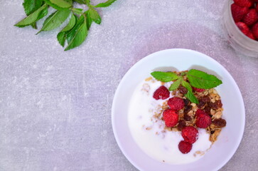 Healthy breakfast. Granola with pumpkin seeds, honey, yogurt and fresh berries in a ceramic bowl on white background.