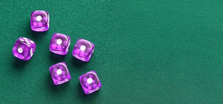 Purple dices on green background with space for text