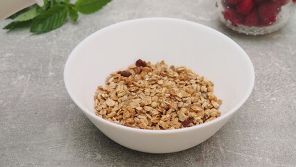 bowl with Greek yogurt homemade granola, mixed nuts, almond, cashew, hazelnut. Healthy vegetarian protein diet breakfast. Selective focus, closeup