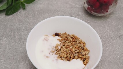 bowl with Greek yogurt homemade granola, mixed nuts, almond, cashew, hazelnut. Healthy vegetarian protein diet breakfast. Selective focus, closeup
