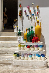 Italy. Locorotondo. Ceramic jugs and dishes on the shop steps.