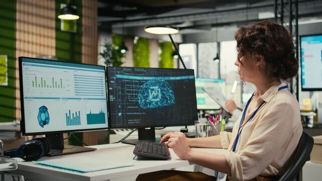 Woman employee using AI machine learning for efficiency recognition, using a synergy of data sharing and optimization models in a co working space. IT company artificial intelligence. Camera A.
