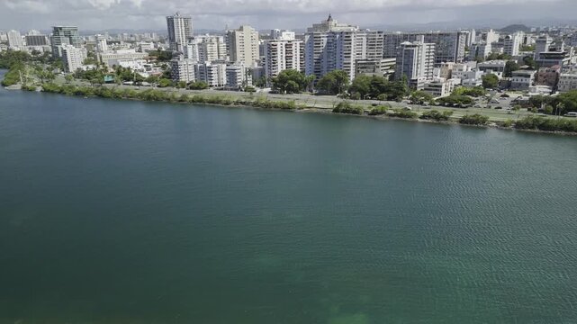 Drone flies south over Laguna del Condado as water goes from shallow to deep in San Juan, Puerto Rico