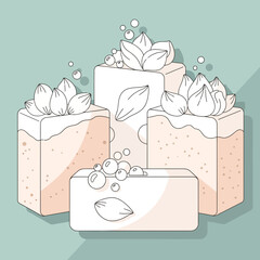 Four soap bars stacked with floral accents on a light blue background.