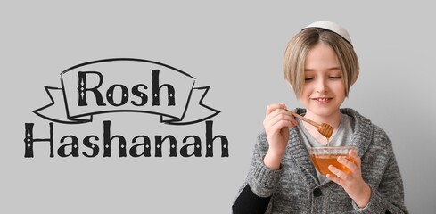 Little boy with honey on grey background. Banner for Rosh Hashanah (Jewish New Year) celebration