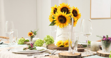 Served dining table with beautiful sunflowers, floral decor and candles