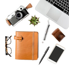 Flat lay of assorted stationery and tech items. A vintage camera, leather notebook, laptop, succulent, glasses, pen, phone, and small leather case are arranged on a dark surface
