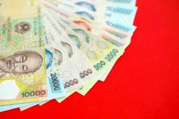 Vietnamese dong money bills in big amount on red. Finance and banking concept