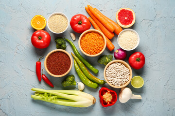 Different fresh vegetables and cereals on blue background