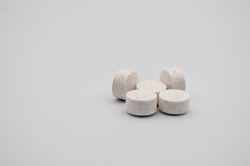 White Effervescent Tablets Arranged on a Plain Light Background for Product Display