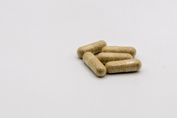 Natural Herbal Supplement Capsules on White Background for Health and Wellness Display