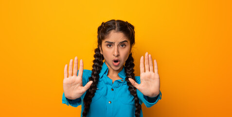 Stop Violence And Discrimination. Portrait of a serious young indian woman standing with both...