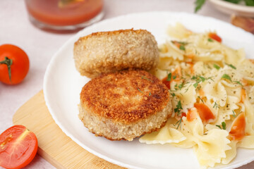 Plate of tasty meat cutlets with pasta on white background