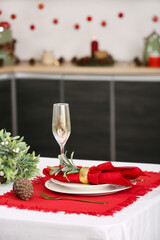 Beautiful Christmas table setting with dishes in kitchen, closeup