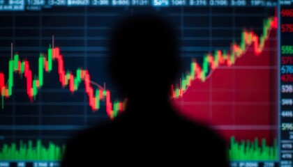 A silhouette of a person observing a digital screen displaying colorful stock market charts, with bright green and red candlestick patterns in a dark, futuristic setting