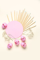 Composition with pencils, gypsophila, Easter eggs and empty card on white background. Easter concept.