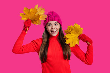 Autumn foliage. Autumn and leisure. Fall leaves and beautiful girl. Stylish girl hold maple leaves. Fall season. Hello autumn. Carefree teen girl in hat and gloves isolated on pink. Seasonal mood