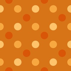 Orange circles are evenly distributed across a darker orange background, creating a seamless polka dot pattern. The varying shades of orange add depth and interest to the design.
