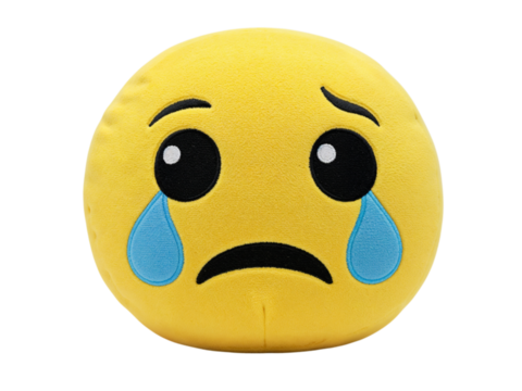 A sad crying emoji pillow plush toy with blue tears expressing disappointment and sorrow isolated on transparent background