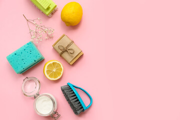Composition with natural cleaning supplies on pink background