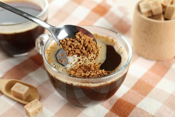 Making aromatic instant coffee at table, closeup
