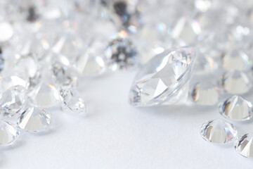 Many shiny diamonds on light background, closeup