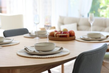 Beautiful table setting, chairs and decor in dining room, closeup. Interior design
