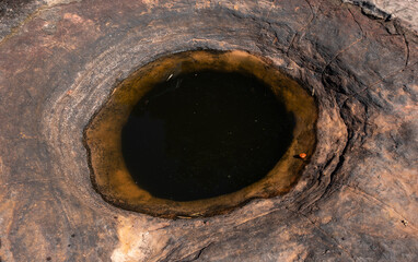 The holy well on Naga Cave, located in the Bueng Kan province of Northeastern Thailand. This strange and amazing beauty of the hole stone shaped like a giant snake eye.