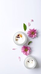 Two charming small glass jars, each filled with delicate white candles and vibrant pink flowers, create a lovely, inviting ambiance perfect for decor.