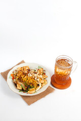 Traditional food and drink menu in the form of Solo tofu kupat and sweet iced tea isolated on a white background