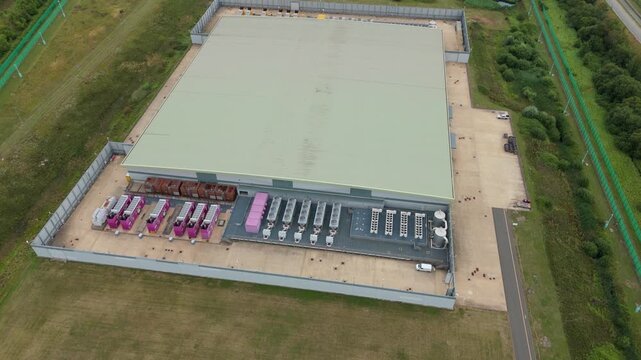 Top down aerial drone view of large data center in England, UK futuristic cutting edge technology with cooling fans and quantum computing data storage.