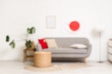 Blurred view of living room with Japanese flag, sofa and table