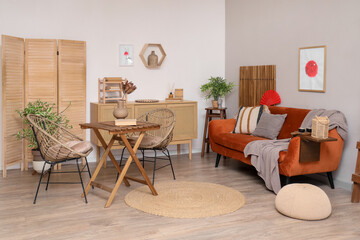 Interior of living room with Japanese flag pictures, sofa and armchairs