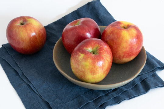 Four Cosmic Crisp Apples in a Bowl