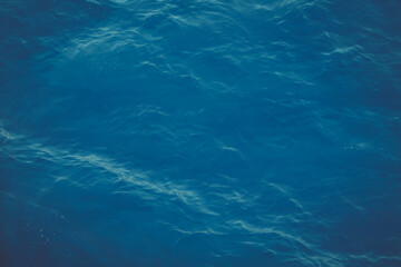 dark blue water surface with ripples