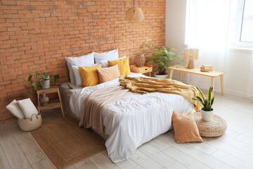 Interior of modern bedroom with brick wall