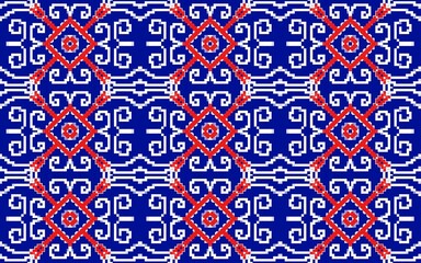 Intricate geometric pattern featuring a repeated design of red and white shapes on a bold blue background. 