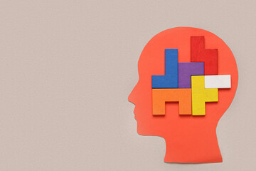 Paper human head with many colorful blocks on grey background. Logic concept