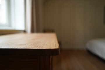 Close Up Wooden Table Edge in a Softly Lit Bedroom with Natural Light