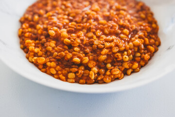 cooked freekeh with lentils and tomato sauce for a healthy vegetarian meal
