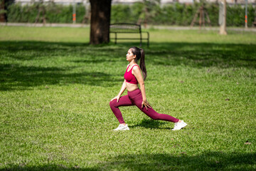 A woman is stretching in a park