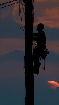 Silhouette of an electrical worker performing essential repairs on utility poles during a dramatic sunset. The tools gleam in the fading light symbolizing the critical role of maintenance