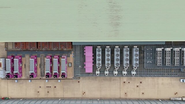 Top down aerial drone view of large data center in England, UK futuristic cutting edge technology with cooling fans and quantum computing data storage.