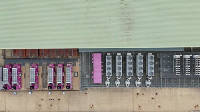 Top down aerial drone view of large data center in England, UK futuristic cutting edge technology with cooling fans and quantum computing data storage.